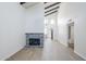 A bright living room features vaulted ceilings and a unique tiled fireplace with modern flooring at 2223 E Catalina Dr, Phoenix, AZ 85016