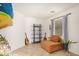 Relaxing bonus room with neutral walls, tile flooring, a convertible couch, and modern decor at 22670 N Kennedy Dr, Maricopa, AZ 85138