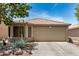 Charming single-story home with a two-car garage, low maintenance desert landscaping, and a tile roof at 22670 N Kennedy Dr, Maricopa, AZ 85138