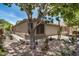 Single-story home with desert landscaping, including cacti and agave plants, and a well-maintained yard at 22670 N Kennedy Dr, Maricopa, AZ 85138