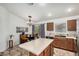Bright kitchen features an island, dining table, and stainless steel dishwasher at 22670 N Kennedy Dr, Maricopa, AZ 85138
