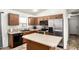 Functional kitchen with stainless steel appliances, wood cabinets, and an island, ready for cooking and entertaining at 22670 N Kennedy Dr, Maricopa, AZ 85138