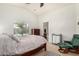 Bright main bedroom with a pool view, ceiling fan, and a private entrance to the bathroom at 22670 N Kennedy Dr, Maricopa, AZ 85138