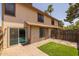 Cozy backyard features artificial grass and a brick patio with a sliding glass door entry at 2455 E Broadway Rd # 122, Mesa, AZ 85204