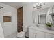Modern bathroom features white tile, a decorative wood accent wall, and updated fixtures at 2455 E Broadway Rd # 122, Mesa, AZ 85204