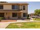 Charming two-story home with manicured front lawn, inviting entrance, and carport at 2455 E Broadway Rd # 122, Mesa, AZ 85204