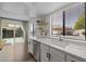 The kitchen offers stainless appliances, bright countertops, and access to the backyard through a sliding glass door at 2455 E Broadway Rd # 122, Mesa, AZ 85204