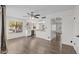 Spacious living room with kitchen view, updated flooring, and plenty of natural light from large windows at 2455 E Broadway Rd # 122, Mesa, AZ 85204