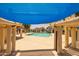 View from beneath a poolside pergola, showcasing the community pool and surrounding area at 2455 E Broadway Rd # 122, Mesa, AZ 85204