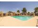 A community pool area surrounded by lush desert landscaping and beautiful shade features at 2455 E Broadway Rd # 122, Mesa, AZ 85204