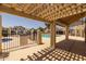 View of community pool deck with pergola shade structure and pool rules sign at 2455 E Broadway Rd # 122, Mesa, AZ 85204