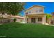 A lush green lawn with a covered patio, trees, and a block fence at 25210 N 40Th Ave, Phoenix, AZ 85083