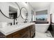 Modern bathroom featuring double sinks, a soaking tub, and stylish fixtures at 25210 N 40Th Ave, Phoenix, AZ 85083