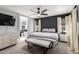 Inviting main bedroom features neutral tones, a ceiling fan, with a cozy seating bench and ensuite bathroom at 25210 N 40Th Ave, Phoenix, AZ 85083