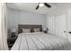 Bright bedroom with a ceiling fan, gray headboard, soft lighting, and a calming neutral color palette at 25210 N 40Th Ave, Phoenix, AZ 85083