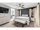 Inviting main bedroom features neutral tones, a ceiling fan, with a cozy seating bench and ensuite bathroom at 25210 N 40Th Ave, Phoenix, AZ 85083