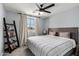 Well-lit bedroom with cozy atmosphere, comfortable bed and a small bookcase with books at 25210 N 40Th Ave, Phoenix, AZ 85083