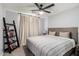 Charming bedroom featuring neutral walls, a ceiling fan, and a comfy bed with striped bedding at 25210 N 40Th Ave, Phoenix, AZ 85083