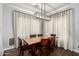Inviting dining room featuring a modern chandelier and large windows for natural light at 25210 N 40Th Ave, Phoenix, AZ 85083