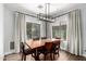 Inviting dining room featuring a modern chandelier and large windows for natural light at 25210 N 40Th Ave, Phoenix, AZ 85083