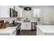 Bright kitchen featuring white cabinets, stainless steel appliances, and stylish backsplash at 25210 N 40Th Ave, Phoenix, AZ 85083