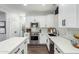 Well-lit kitchen showcasing white cabinets, stainless steel appliances, and an island with marble countertop at 25210 N 40Th Ave, Phoenix, AZ 85083