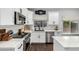 Bright kitchen featuring white cabinets, stainless steel appliances, and stylish backsplash at 25210 N 40Th Ave, Phoenix, AZ 85083