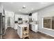 Well-lit kitchen showcasing white cabinets, stainless steel appliances, and an island with marble countertop at 25210 N 40Th Ave, Phoenix, AZ 85083