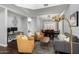 Open-concept living area featuring modern furniture, wood floors, and a view to the dining space at 25210 N 40Th Ave, Phoenix, AZ 85083
