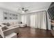 Spacious living room with wood floors, a ceiling fan, and sliding glass doors to the backyard at 25210 N 40Th Ave, Phoenix, AZ 85083