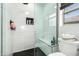 Bright modern bathroom features a glass shower, tiled walls, and a comfortable built-in bench at 25210 N 40Th Ave, Phoenix, AZ 85083