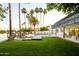 Backyard featuring palm trees, a lake, and a nice pool at 2552 S Playa --, Mesa, AZ 85202