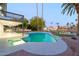 Beautiful backyard with a pool, water view, tropical landscaping, and covered patio at 2552 S Playa --, Mesa, AZ 85202