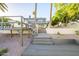 Expansive backyard with elevated deck, stairs leading to the upper level of the white two-story waterfront home at 2552 S Playa --, Mesa, AZ 85202