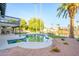 Backyard showcasing a pool, waterfront views, tropical landscaping, and covered patio at 2552 S Playa --, Mesa, AZ 85202