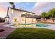 Beautiful backyard with a pool, lush lawn, exterior of the two-story home and balcony at twilight at 2552 S Playa --, Mesa, AZ 85202
