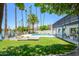 Lush backyard featuring a sparkling pool, lake views, and a covered patio perfect for outdoor relaxation and entertaining at 2552 S Playa --, Mesa, AZ 85202