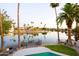 Backyard with palm trees, lake, dock, and a beautiful pool at 2552 S Playa --, Mesa, AZ 85202