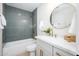 Charming bathroom featuring modern fixtures, a bathtub with shower, and a circular mirror at 2552 S Playa --, Mesa, AZ 85202