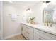 Bright bathroom with dual sinks, white cabinets, and modern gold fixtures at 2552 S Playa --, Mesa, AZ 85202