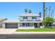 Charming two-story home with a well-manicured lawn, a two-car garage, and inviting curb appeal under a clear sky at 2552 S Playa --, Mesa, AZ 85202