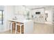 Beautiful kitchen with breakfast bar, white cabinets, stainless steel appliances, and modern countertops at 2552 S Playa --, Mesa, AZ 85202