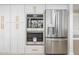 Modern kitchen features a stainless steel refrigerator, built-in ovens, and ample white cabinet space at 2552 S Playa --, Mesa, AZ 85202