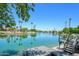 Stunning lake view featuring a private dock, lush palm trees, and crystal-clear water on a sunny day at 2552 S Playa --, Mesa, AZ 85202