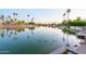 Tranquil lake view showcasing wildlife, waterfront properties, and lush tropical landscaping at 2552 S Playa --, Mesa, AZ 85202