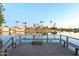 Scenic waterfront view from a private deck on the lake with tropical landscaping and reflections at 2552 S Playa --, Mesa, AZ 85202