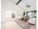 Bright living room with vaulted ceiling, modern furniture, and a large window overlooking the yard at 2552 S Playa --, Mesa, AZ 85202