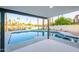 Relaxing pool area with serene waterfront views, palm trees, and a covered patio with modern design at 2552 S Playa --, Mesa, AZ 85202