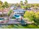 Stunning waterfront home featuring a private pool, dock, and lush tropical landscaping with mature palm trees at 2552 S Playa --, Mesa, AZ 85202