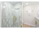 Modern walk-in shower featuring gray and white tile, gold fixtures, and glass door at 2552 S Playa --, Mesa, AZ 85202